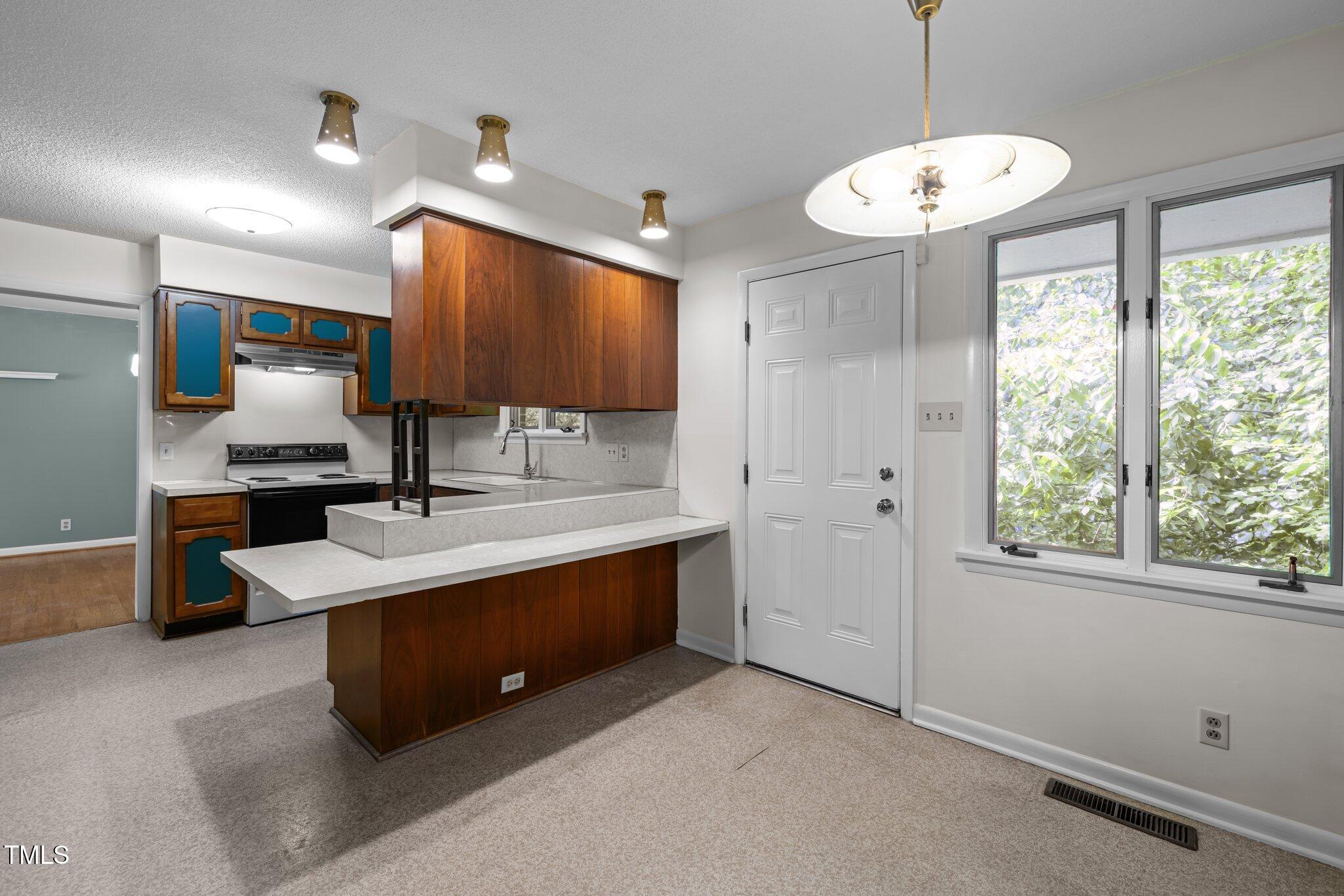 1024 Chalmers Street Durham, NC 27707 - Photo 15 of 41 a bathroom with a sink a large mirror and a shower