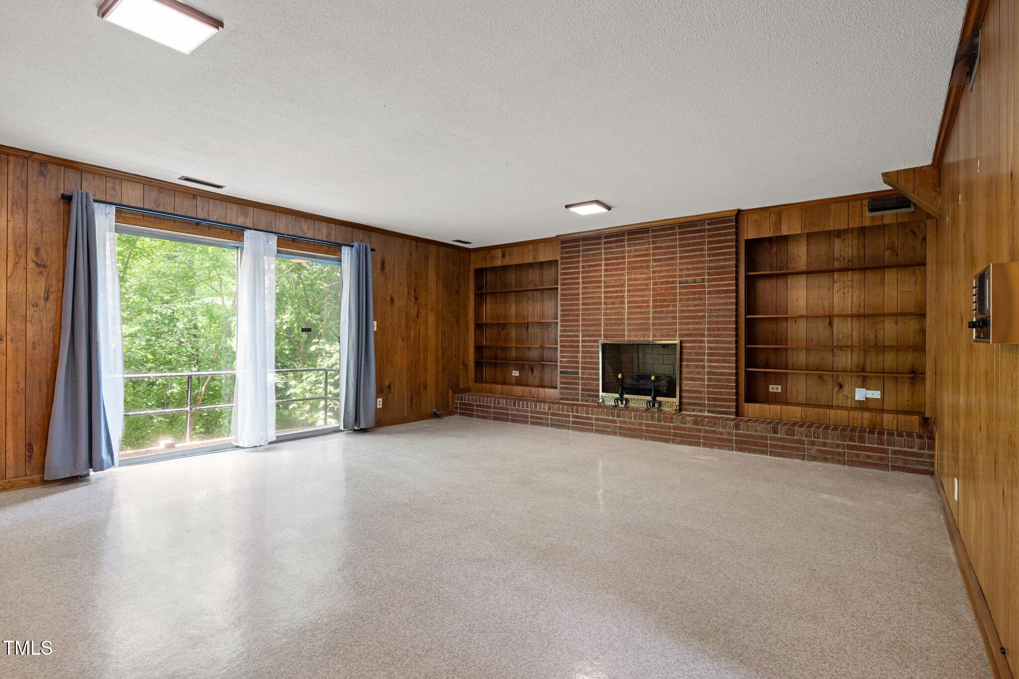 1024 Chalmers Street Durham, NC 27707 - Photo 18 of 41 a view of empty room with fireplace and window