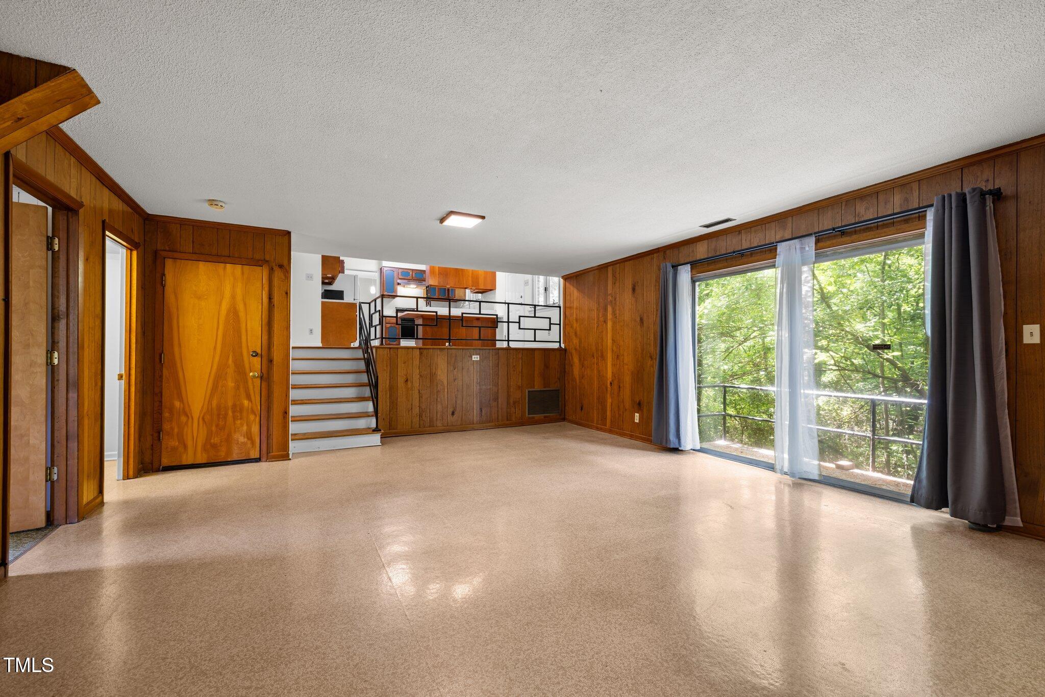 1024 Chalmers Street Durham, NC 27707 - Photo 20 of 41 a view of a big room with large windows and stairs