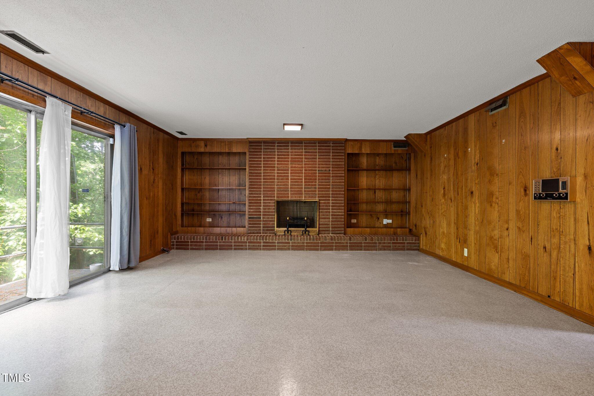 1024 Chalmers Street Durham, NC 27707 - Photo 21 of 41 a view of an empty room with a fireplace and a window