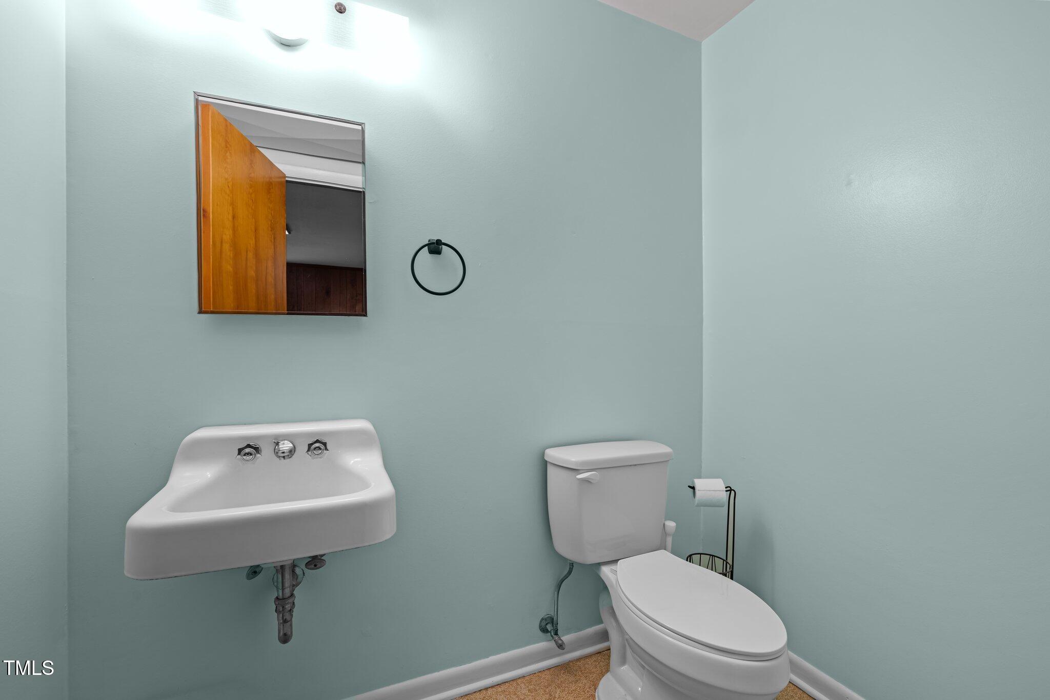 1024 Chalmers Street Durham, NC 27707 - Photo 23 of 41 a white toilet sitting next to a bathroom sink
