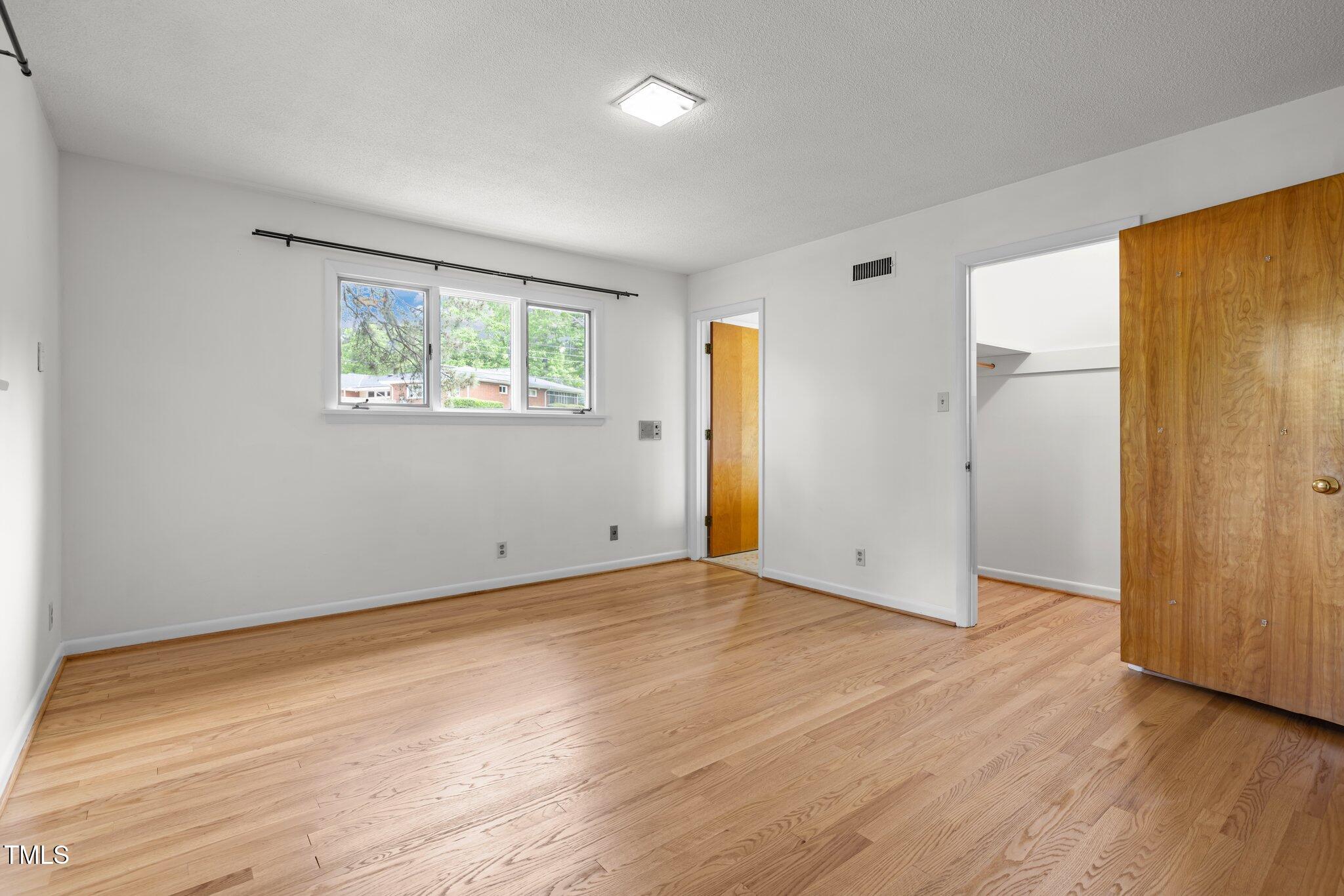 1024 Chalmers Street Durham, NC 27707 - Photo 26 of 41 an empty room with wooden floor and a window