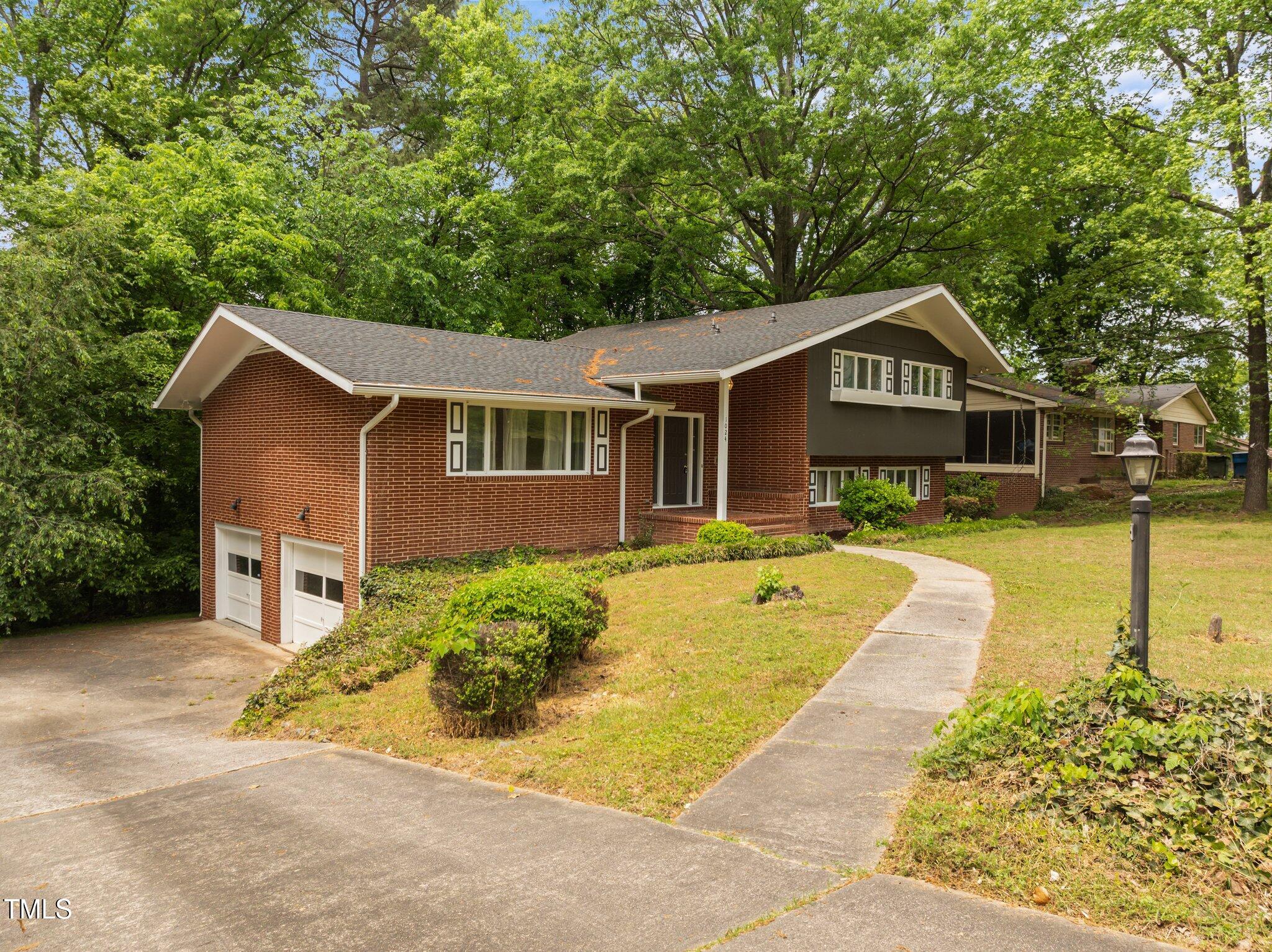 1024 Chalmers Street Durham, NC 27707 - Photo 2 of 41 a front view of a house with a yard