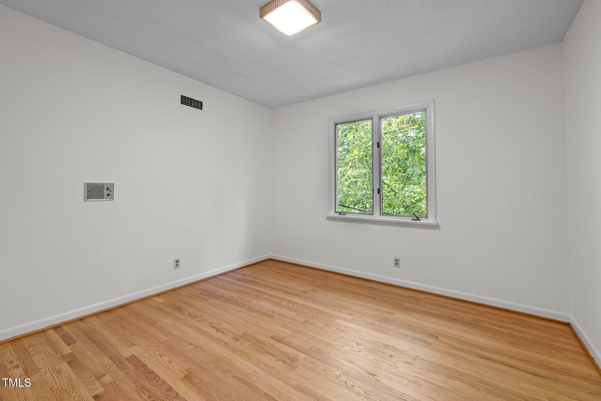 1024 Chalmers Street Durham, NC 27707 - Photo 31 of 41 wooden floor in an empty room with a window