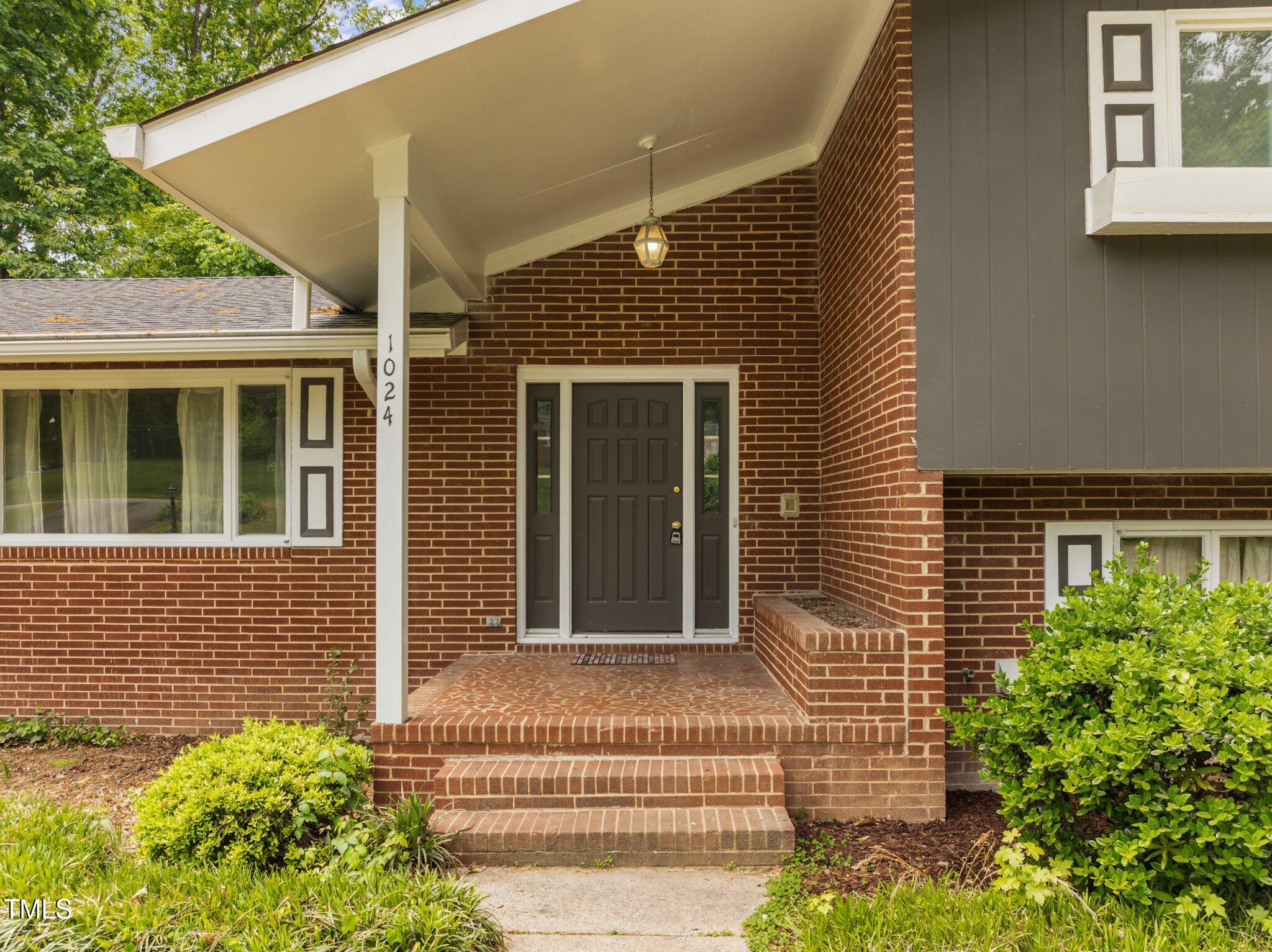 1024 Chalmers Street Durham, NC 27707 - Photo 3 of 41 a front view of a house with a garden