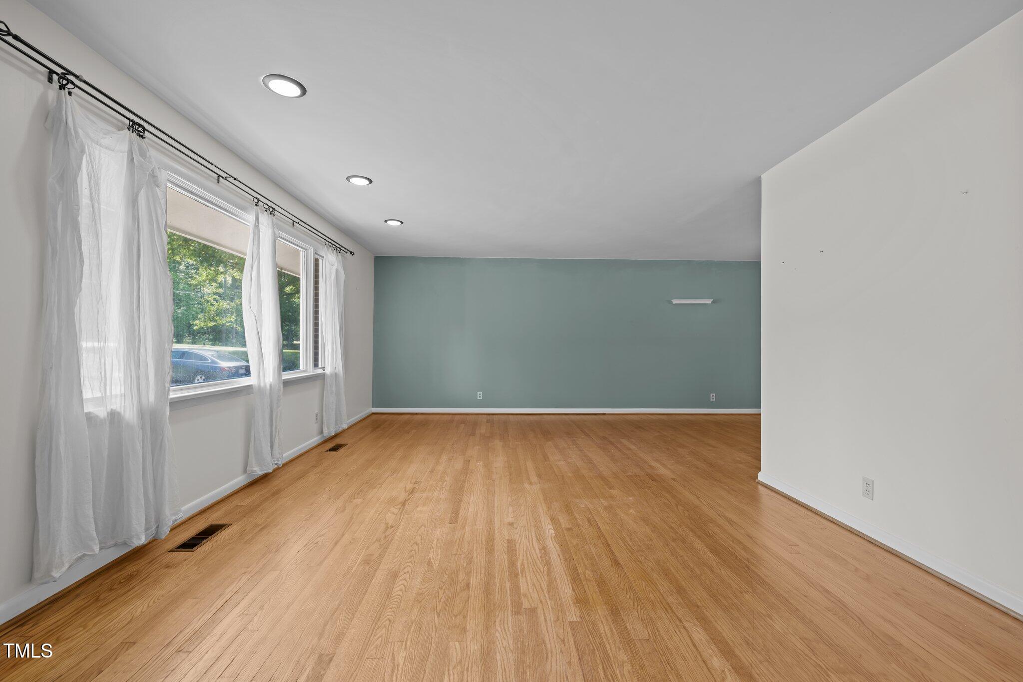1024 Chalmers Street Durham, NC 27707 - Photo 6 of 41 wooden floor in an empty room with a window