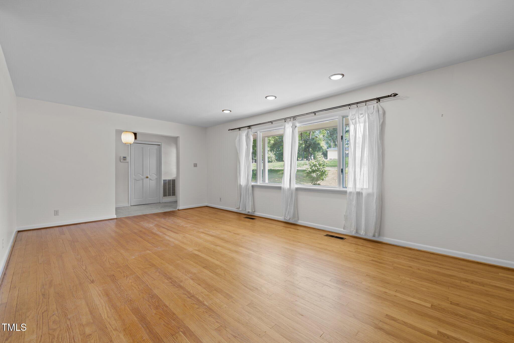 1024 Chalmers Street Durham, NC 27707 - Photo 7 of 41 a view of an empty room with wooden floor and a window