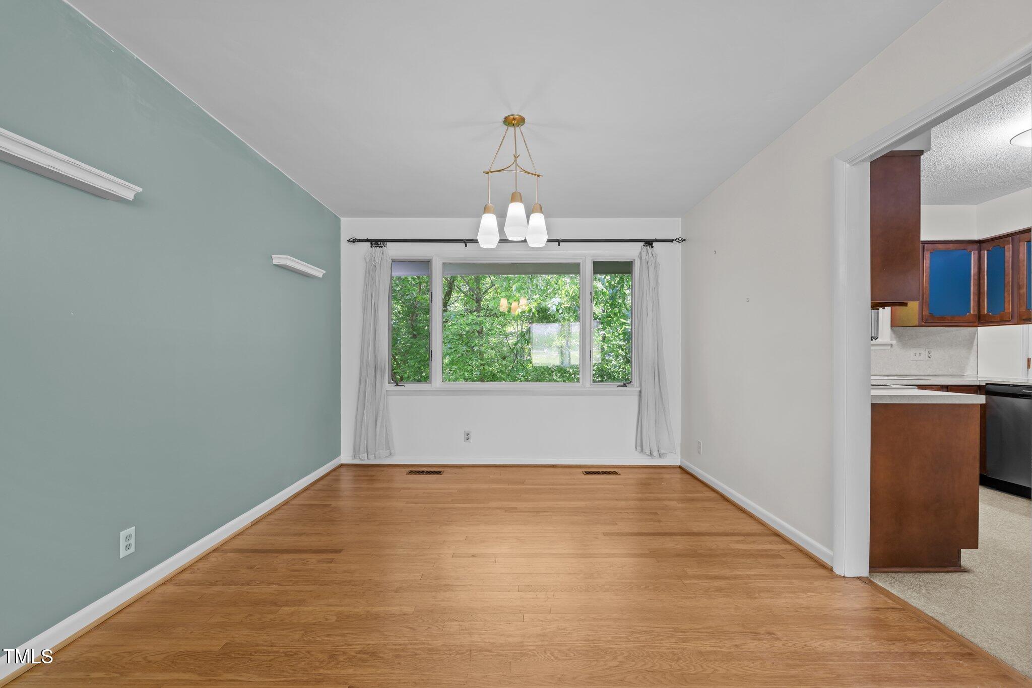 1024 Chalmers Street Durham, NC 27707 - Photo 9 of 41 a view of empty room with wooden floor and fan