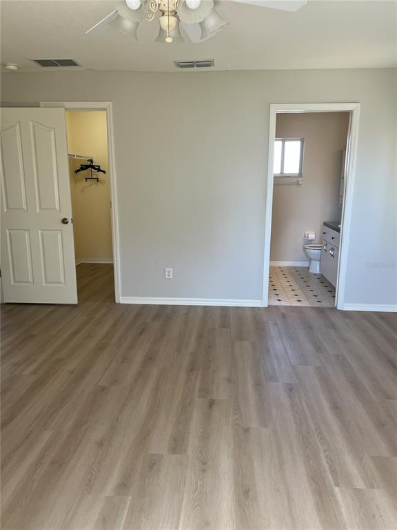 6035 Southwest 98th Street Road Ocala, FL 34476 - Photo 8 of 15 an empty room with wooden floor and closet
