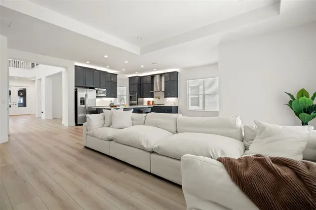 a white kitchen with granite countertop a sink and white cabinets