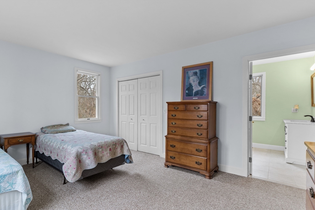 376 Pleasant Bay Road Harwich, MA 02645 - Photo 11 of 17 a bedroom with a bed and a chair