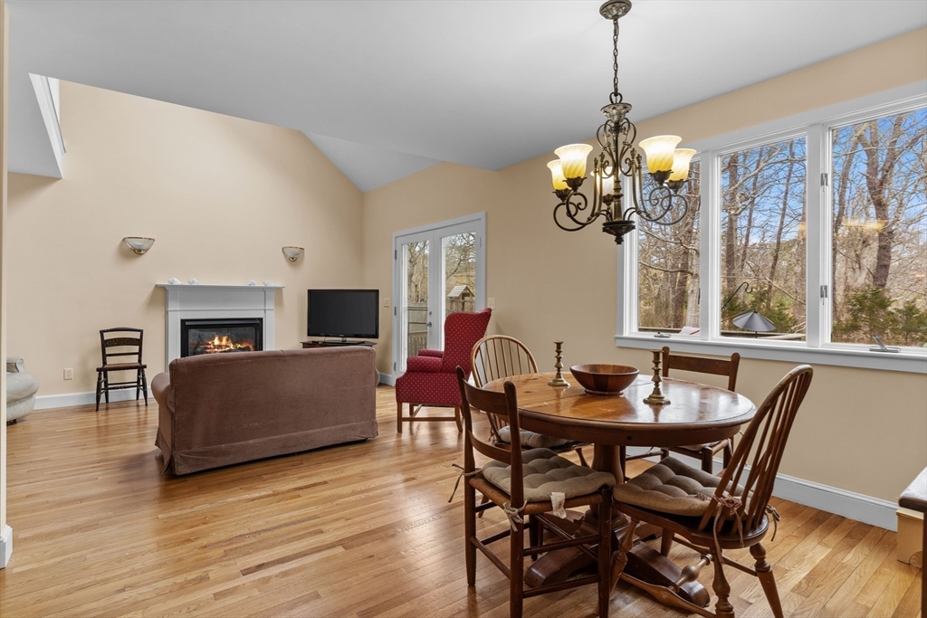 376 Pleasant Bay Road Harwich, MA 02645 - Photo 5 of 17 a dining room with furniture a chandelier and wooden floor