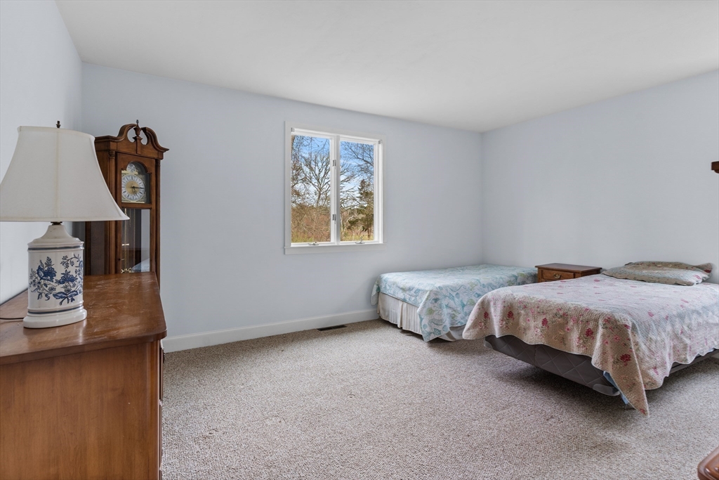 376 Pleasant Bay Road Harwich, MA 02645 - Photo 8 of 17 a spacious bedroom with a bed and a window