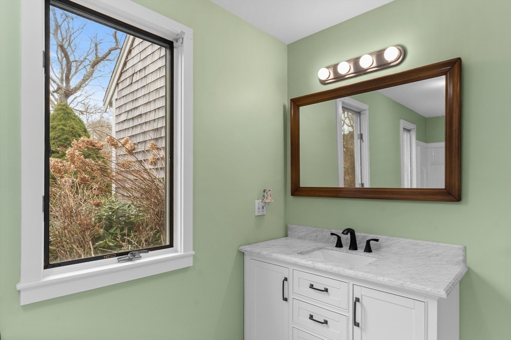 376 Pleasant Bay Road Harwich, MA 02645 - Photo 10 of 17 a bathroom with a sink vanity and a mirror
