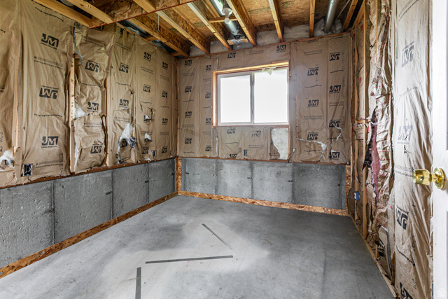 4239 West 5325th Street South Roy, UT 84067 - Photo 18 of 26 Unfinished basement space featuring exposed wood framing, concrete foundation walls, and a visible window opening