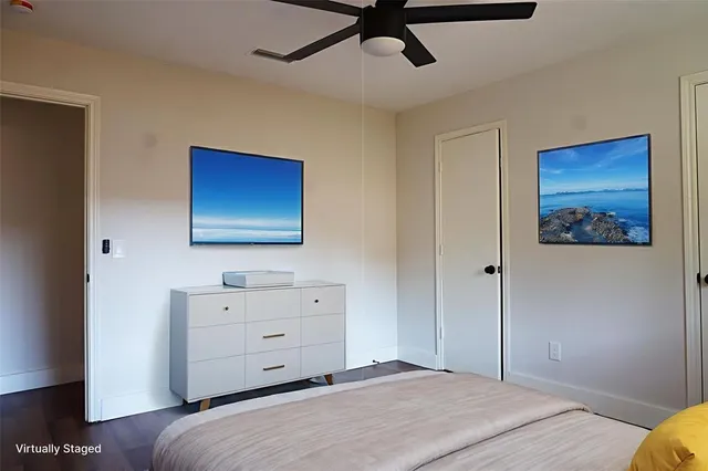 a bedroom with a bed and a dresser in it