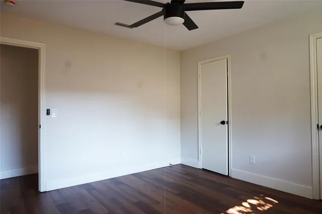 a view of room with window and wooden floor
