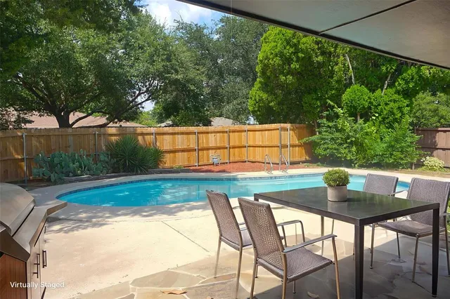 a view of swimming pool with a patio