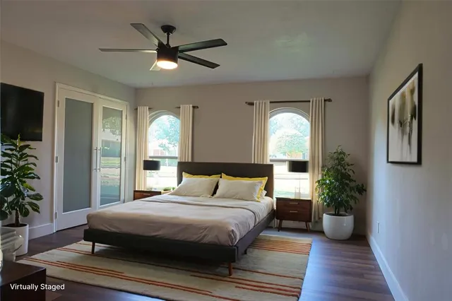 a bedroom with a large bed and a chandelier