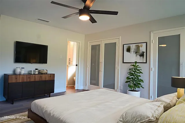 a bedroom with a bed and a flat screen television