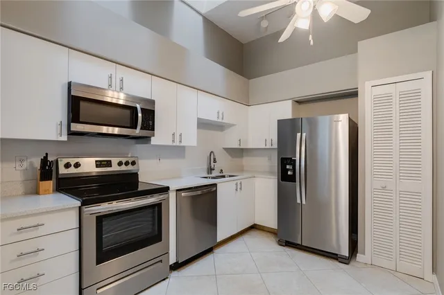 a kitchen with a refrigerator stove and microwave