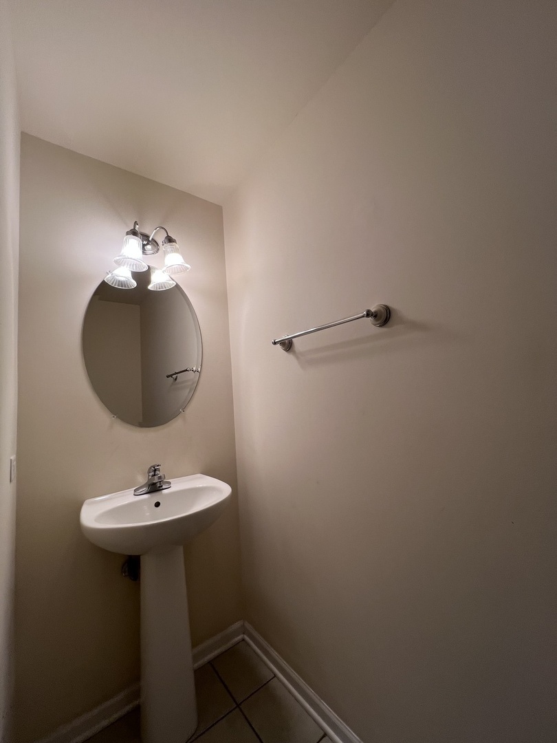 554 Prestwick Lane, Unit 554 Wheeling, IL 60090 - Photo 13 of 30 a bathroom with a sink and a mirror