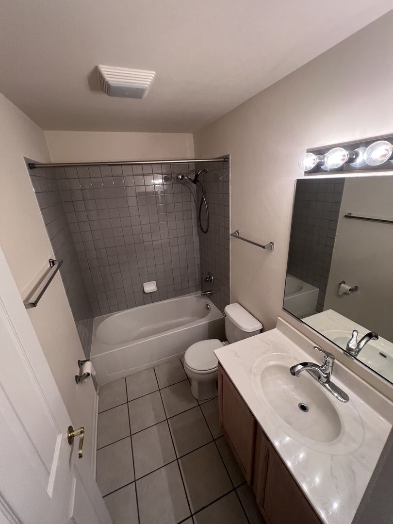554 Prestwick Lane, Unit 554 Wheeling, IL 60090 - Photo 24 of 30 a bathroom with a double vanity sink toilet and shower