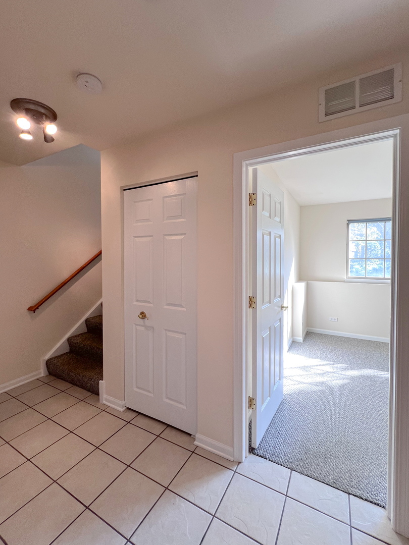 554 Prestwick Lane, Unit 554 Wheeling, IL 60090 - Photo 27 of 30 a view of a livingroom with a staircase