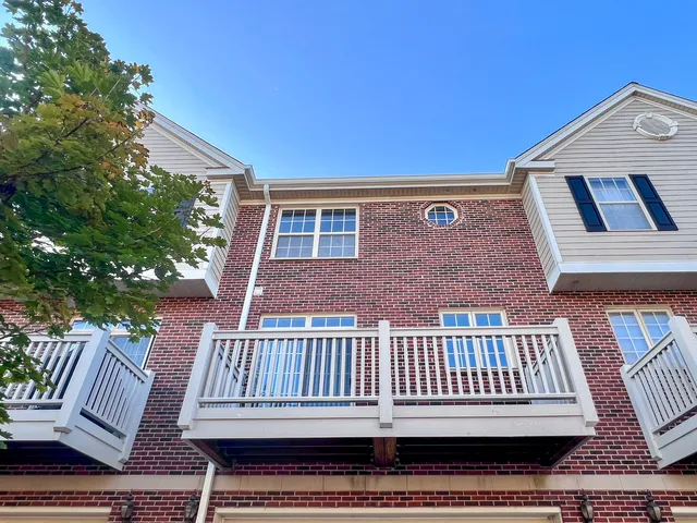 a view of a brick house with a bench
