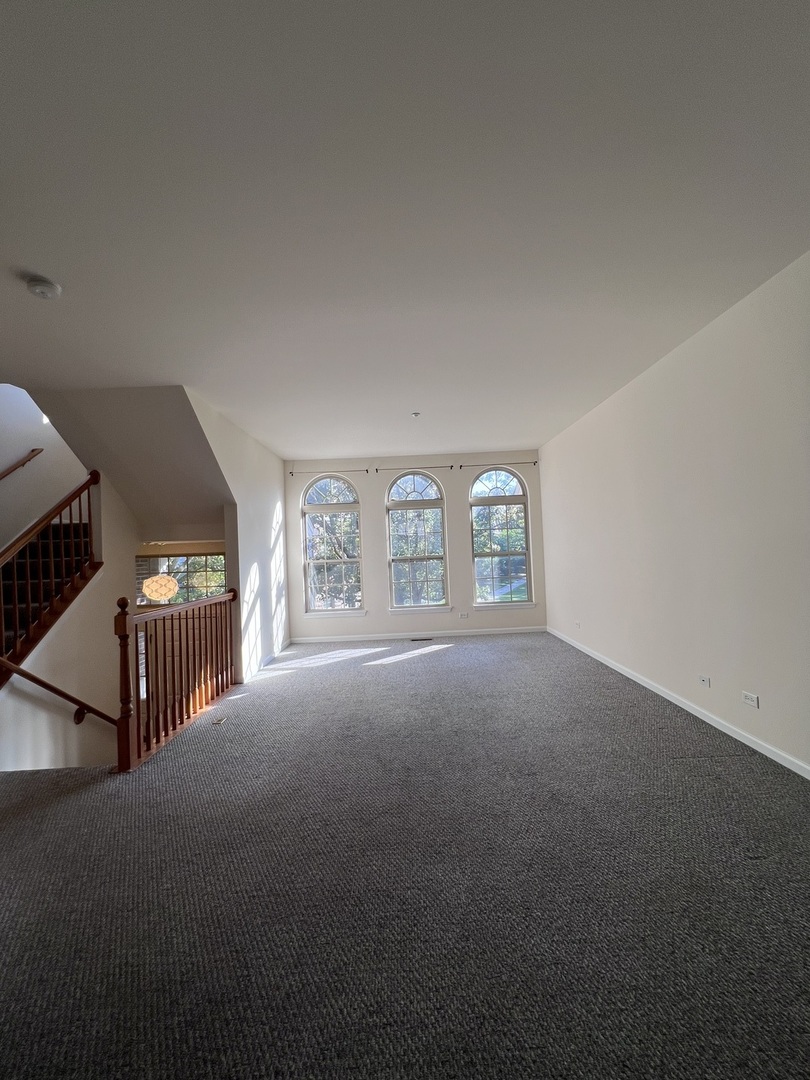 554 Prestwick Lane, Unit 554 Wheeling, IL 60090 - Photo 6 of 30 a view of an empty room with stairs