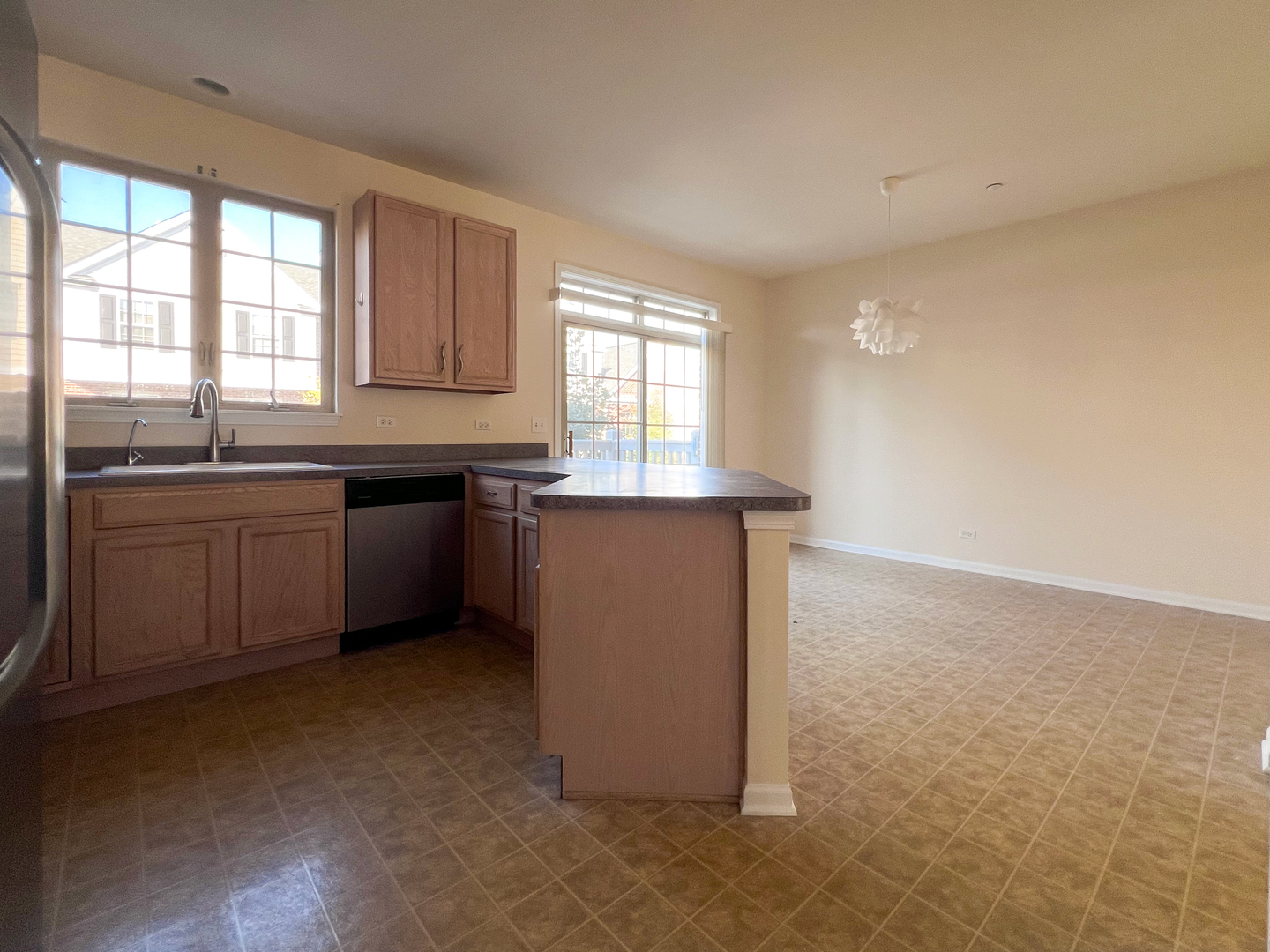 554 Prestwick Lane, Unit 554 Wheeling, IL 60090 - Photo 8 of 30 a kitchen with a sink cabinets and window