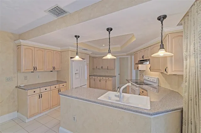 a kitchen with white cabinets and white appliances
