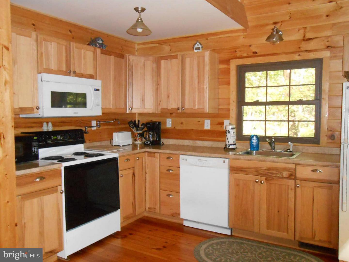 1280 Mountainside Road Berkeley Springs, WV 25411 - Photo 12 of 21 Wood cabinet, wood floors in kitchen
