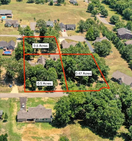 an aerial view of a houses with yard swimming pool and outdoor seating