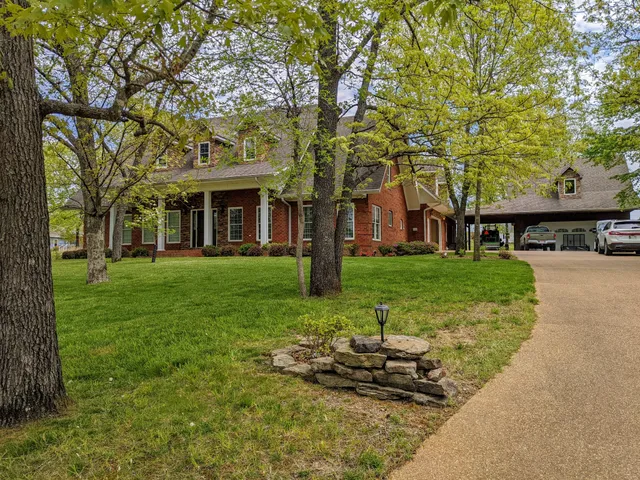 a view of a house with backyard porch and sitting area