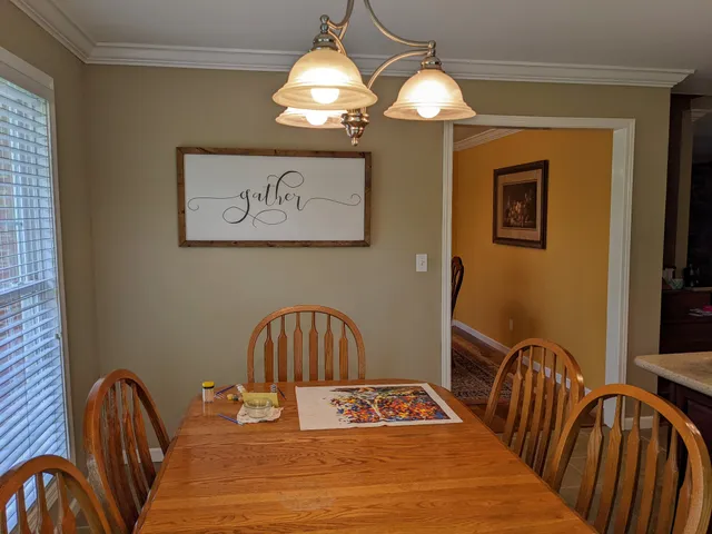 a dining room with furniture and window