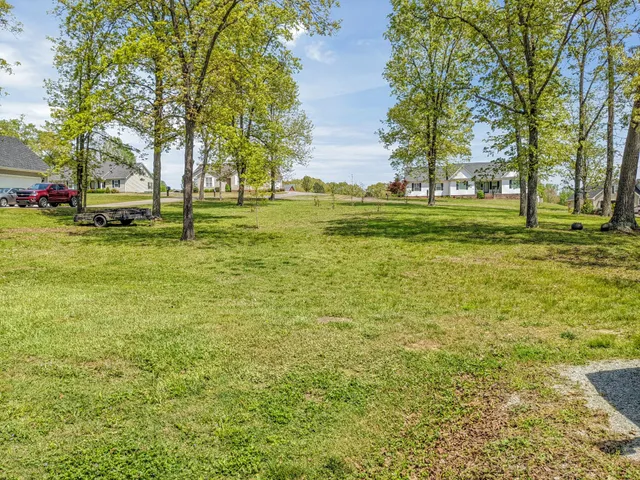 a front view of a building with lots of cars parked