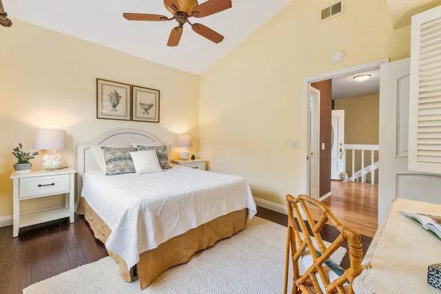 a view of a houses with yard and car parked