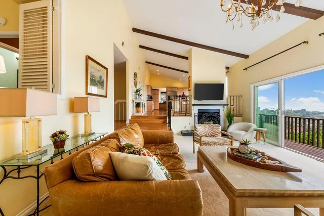 a living room with furniture and a floor to ceiling window