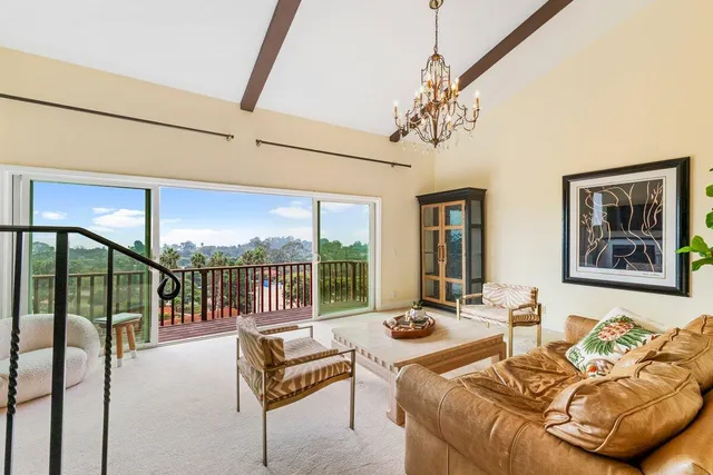 a living room with furniture fireplace and a large window