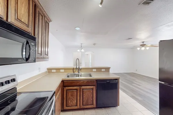 a kitchen with a sink and a refrigerator
