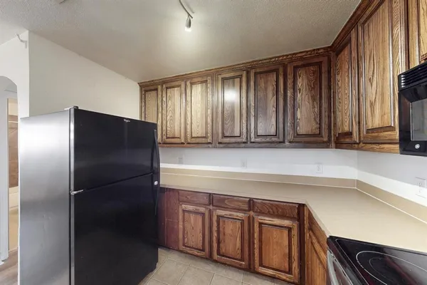 a kitchen with a refrigerator and a sink