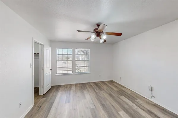 wooden floor in an empty room with a window