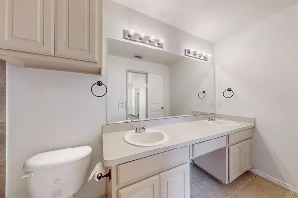 a bathroom with a sink a toilet and mirror