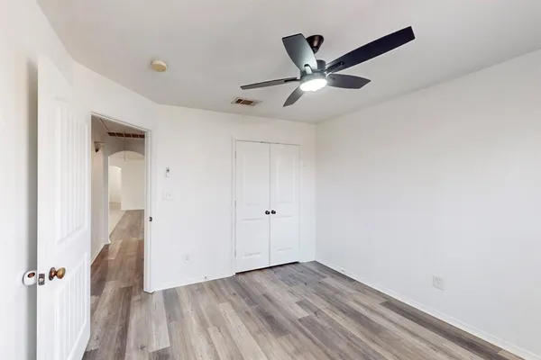 a view of a livingroom with a hardwood floor and a ceiling fan