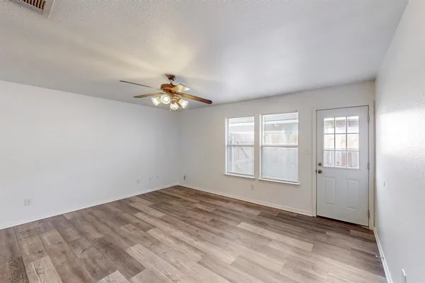 wooden floor in an empty room with a window