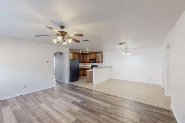 a view of kitchen with cabinet and refrigerator