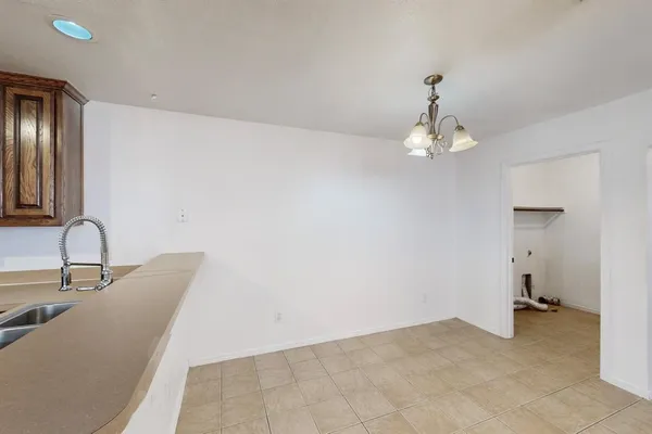 a view of a room with a sink and chandelier