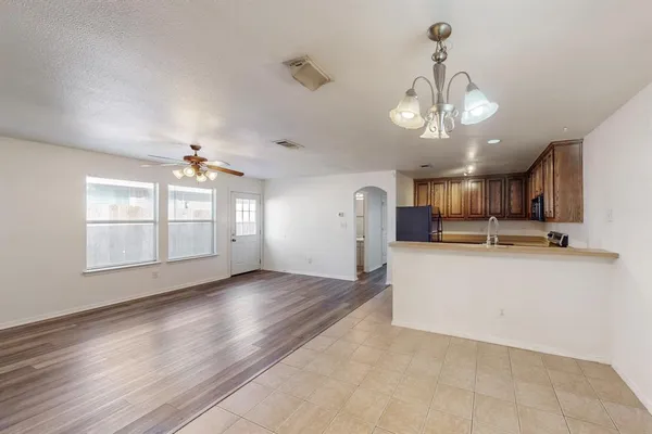 a view of a room with kitchen and window