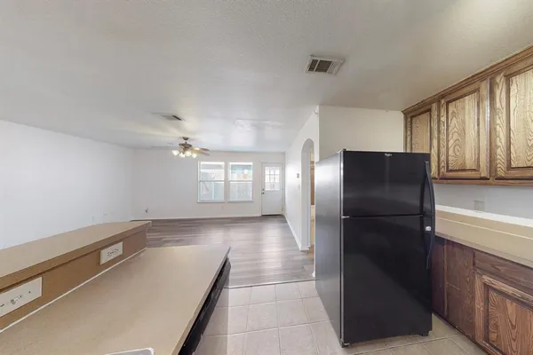 a kitchen with a refrigerator and a sink